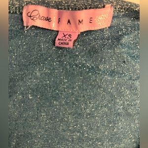 turquoise, shimmery/ glittery, tight shirt